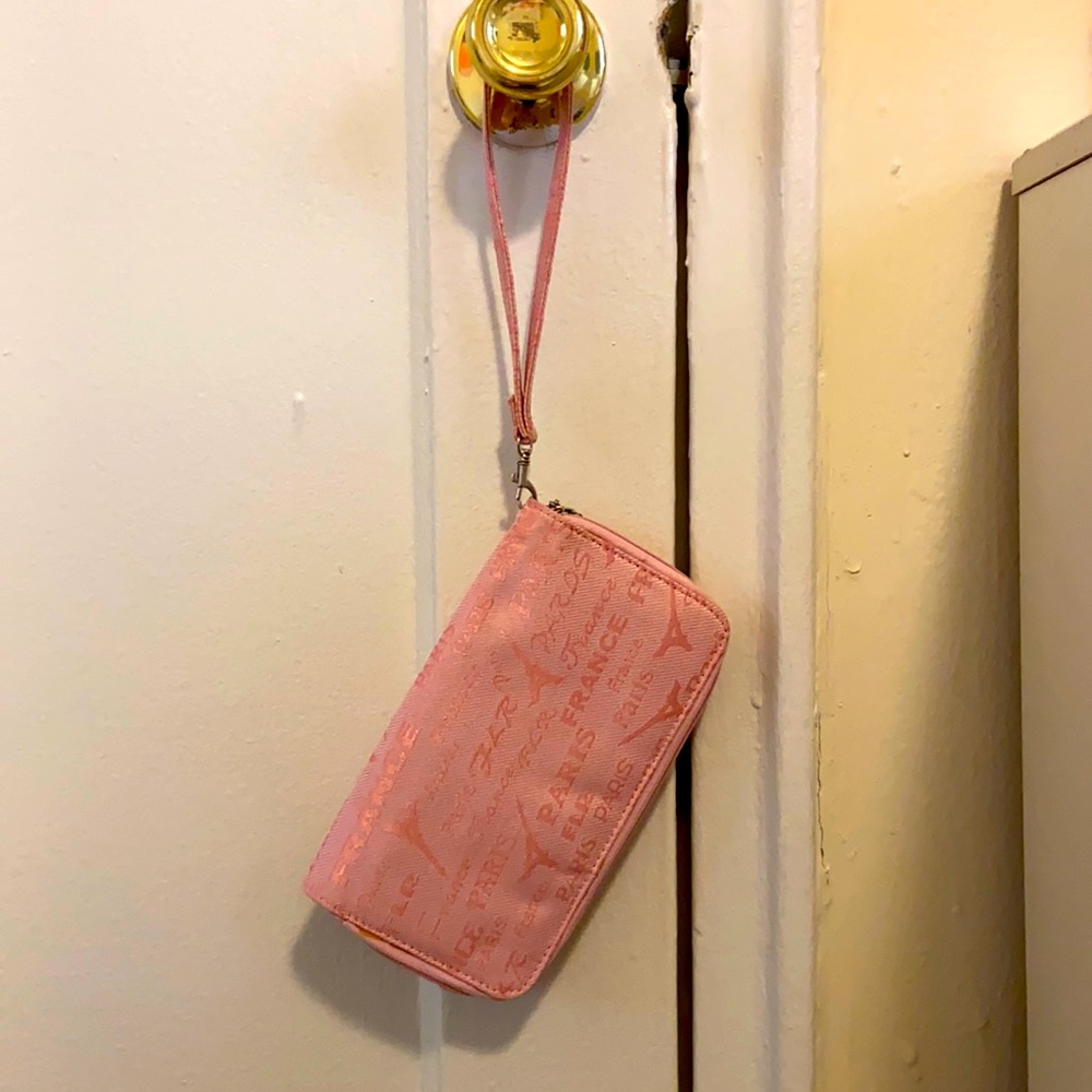 A small pink clutch with hot pink on the inside.